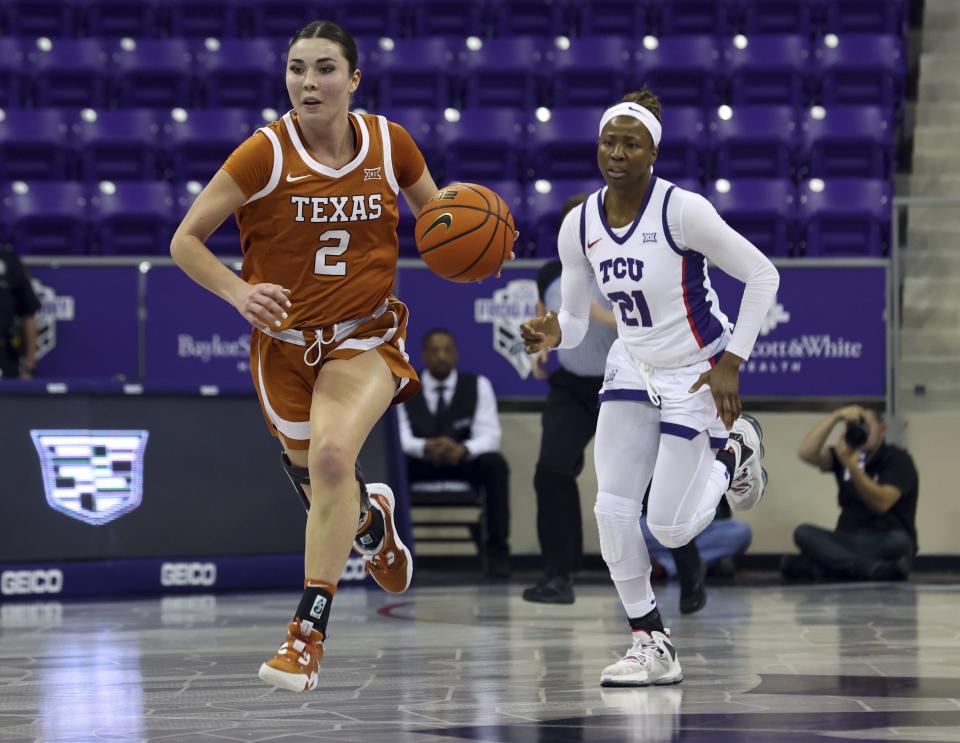 Texas guard Shaylee Gonzales (2) is pursued by TCU forward Lucy Ibeh (21) an NCAA basketball game on Wednesday, Jan. 4, 2023, in Fort Worth, Texas. Gonzales, who played at BYU before transferring to Texas, was named the Big 12 Newcomer of the Year last season. | Richard W. Rodriguez, Associated Press