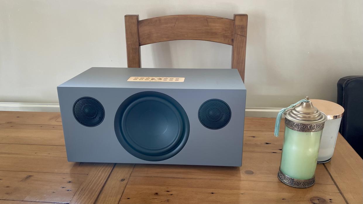  Audio Pro C20 on a wooden table, with a candle nearby. 