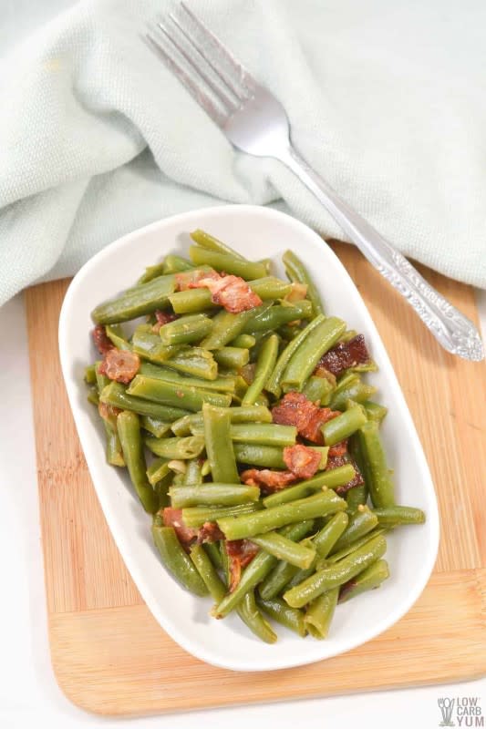 <p>Low Carb Yum</p><p>Cook up a batch of southern green beans in a skillet in just minutes. This keto-friendly recipe uses bacon, onion, and garlic and only has 4g net carbs!</p><p><strong>Get the recipe: </strong><a href="https://lowcarbyum.com/southern-green-beans/" rel="nofollow noopener" target="_blank" data-ylk="slk:Southern Style Green Beans;elm:context_link;itc:0;sec:content-canvas" class="link "><strong>Southern Style Green Beans</strong></a></p>