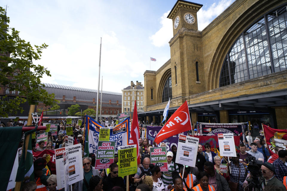 FILE - People holds banners and placards as they attend a RMT (The National Union of Rail, Maritime and Transport Workers) union train strike rally outside King's Cross railway station, in London, June 25, 2022. Across Europe, soaring inflation is behind a wave of protests and strikes that underscores growing discontent with spiralling living costs and threatens to unleash political turmoil. (AP Photo/Matt Dunham, file)