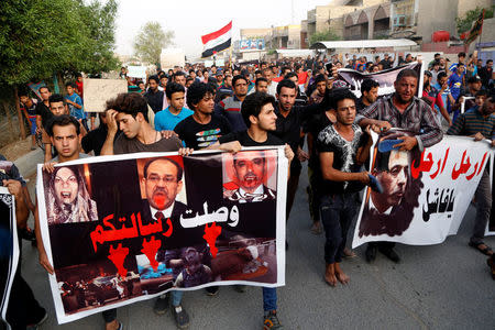 Supporters of the prominent Iraqi Shi'ite cleric Moqtada al-Sadr shout slogans during a protest against security forces, whom they claim is not able to protect them at the site of car bomb attack yesterday in Baghdad's mainly Shi'ite district of Sadr City, Iraq, May 12, 2016. The banner reads, "Your message has arrived". REUTERS/Wissm al-Okili