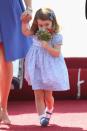<p>Princess Charlotte smells a fresh bouquet of flowers that she was given as she arrived in Berlin, Germany for her second royal tour in 2017. </p>