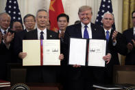 President Donald Trump signs a trade agreement with Chinese Vice Premier Liu He, in the East Room of the White House, Wednesday, Jan. 15, 2020, in Washington. (AP Photo/Evan Vucci)