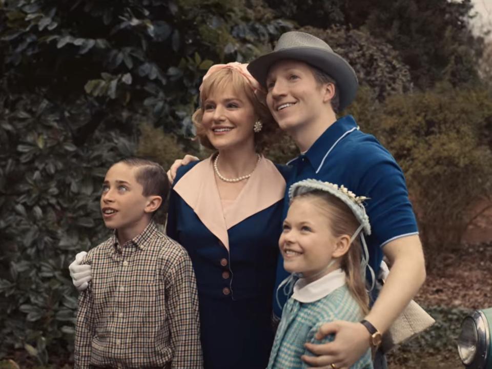 A mother, father, son, and daughter smiling and wearing 1950s style clothing.