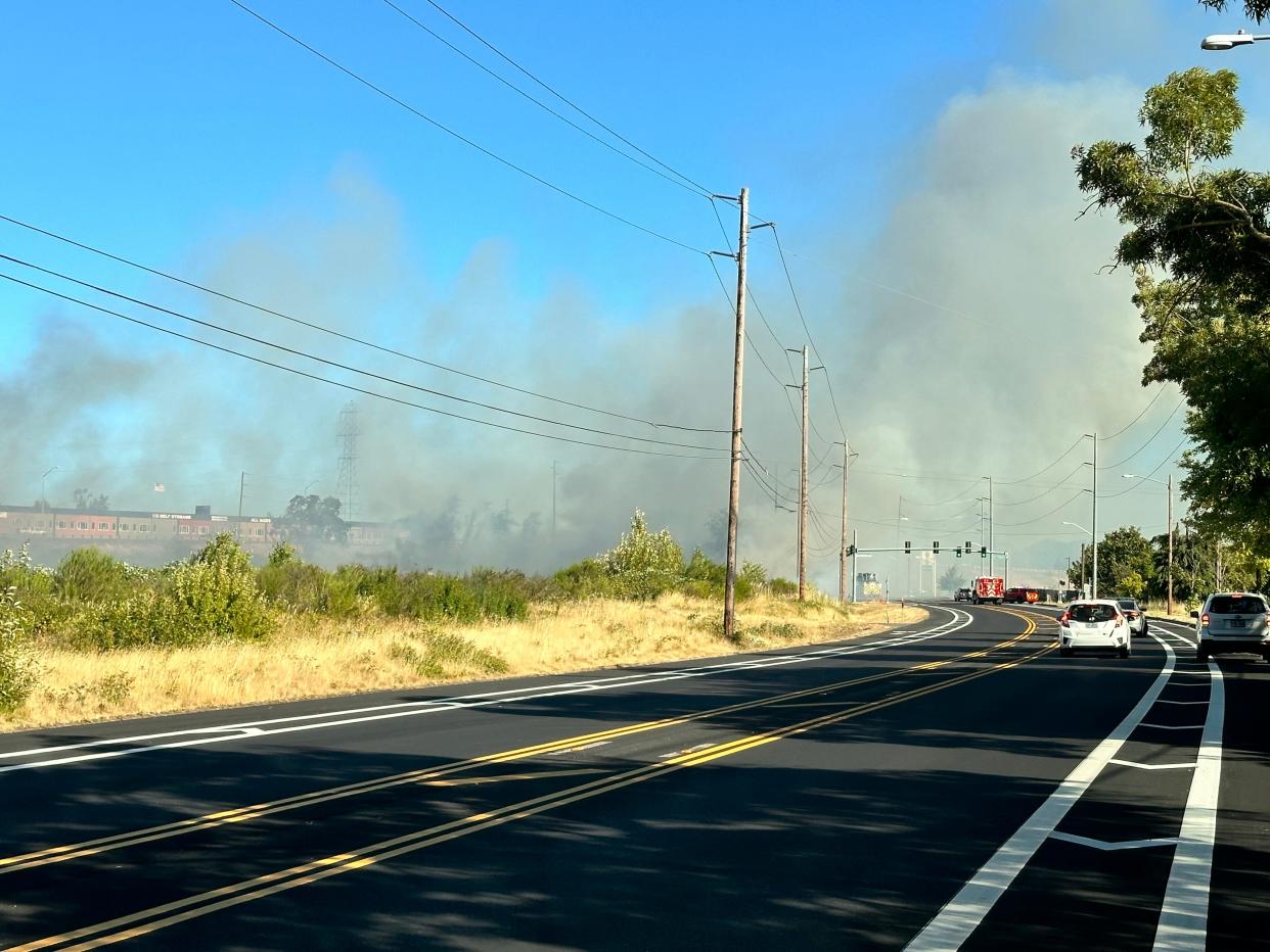 Smoke rises from a brush fire along North Game Farm Rd. on Tuesday afternoon.