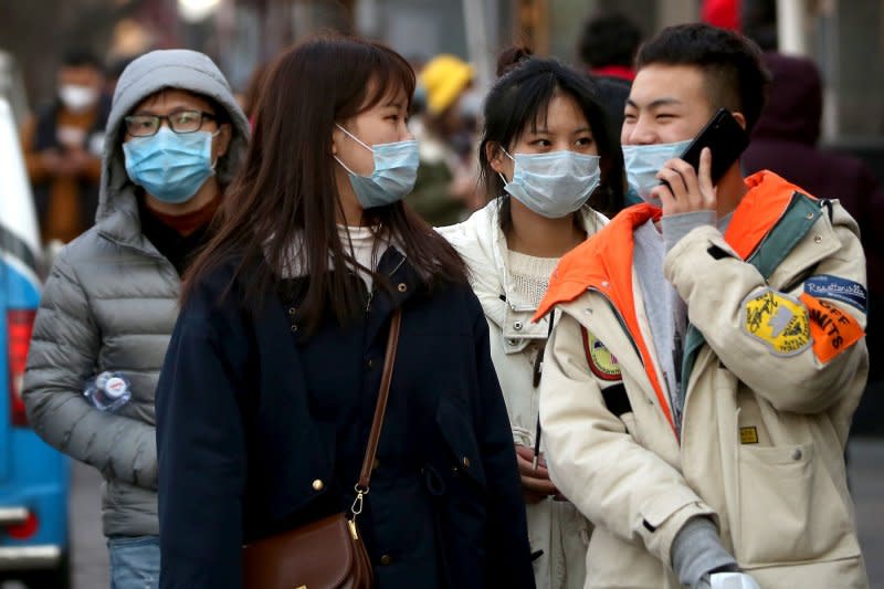 Pedestrians wear protective respiratory masks in Beijing on January 23, 2020, the same day the government issued lockdown orders for the city of Wuhan over a coronavirus outbreak. File Photo by Stephen Shaver/UPI