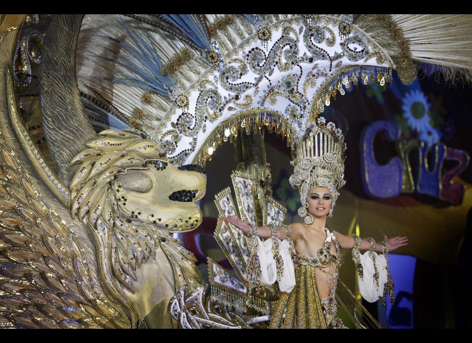 A nomine for Queen of the Santa Cruz carnival shows off her outfit under the watchful eyes of the jury at Santa Cruz de Tenerife on the Spanish Canary island of Tenerife, February 15, 2012. (DESIREE MARTIN/AFP/Getty Images)