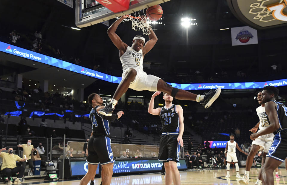 FILE - Georgia Tech forward Moses Wright (5) hangs from the basket after dunking against Duke during the second half of an NCAA college basketball game in Atlanta, in this March 2, 2021, file photo. Wright is The Associated Press men’s basketball player of the year for the Atlantic Coast Conference and a member of the All-ACC first team in voting announced Tuesday, March 9, 2021. (Hyosub Shin/Atlanta Journal-Constitution via AP, File)