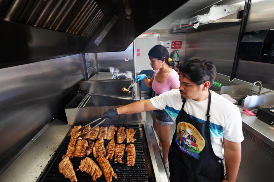 Cooks Marvi Manipol and Elizabeth Timbreza work the kitchen at Filipino Corner food truck on McHenry Avenue and Meily Way in north Modesto, Calif., Friday, June 16, 2023.