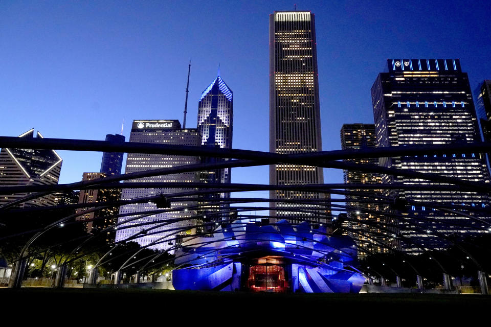 The Chicago skyline rises above the Jay Pritzker Pavilion Amphitheater in the city's Millennium Park Thursday, May 25, 2023. Chicago is heading into the Memorial Day weekend hoping to head off violence that tends to surge with rising temperatures of summer. Even the state of Illinois is assisting by sending in what it's called "peacekeepers" in an attempt to deescalate violent situations. (AP Photo/Charles Rex Arbogast)