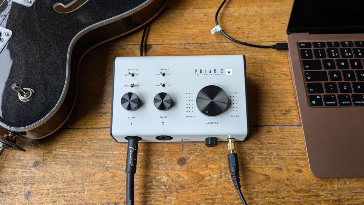  A Blackstar Polar 2 audio interface on a wooden floor with a laptop and a semi-hollow guitar. 