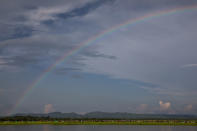 <p>A rainbow hovers above thousands of Rohingya refugees fleeing from Myanmar are kept under a tight security by Bangladeshi military after crossing the border in a rice paddy field near Palang Khali, Cox’s Bazar, Bangladesh, on October 16, 2017. A rainbow appeared after a brief rainstorm. (Photograph by Paula Bronstein/Getty Images) </p>