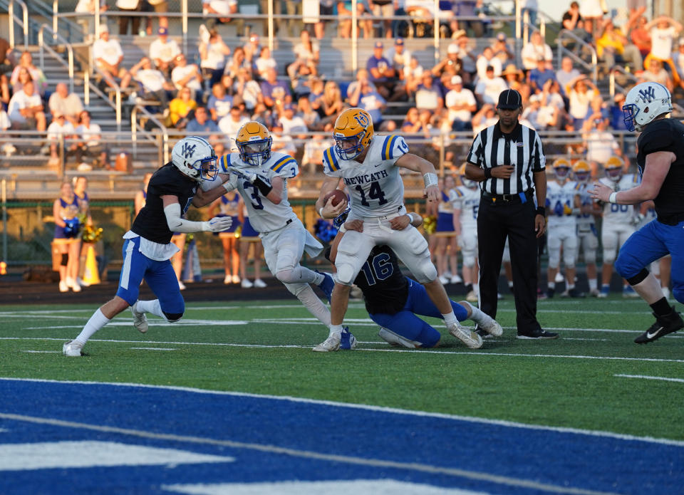 Newport Central Catholic quarterback Kolton Smith tries to break a tackle close to the endzone at Walton-Verona High School Sept. 8, 2022.