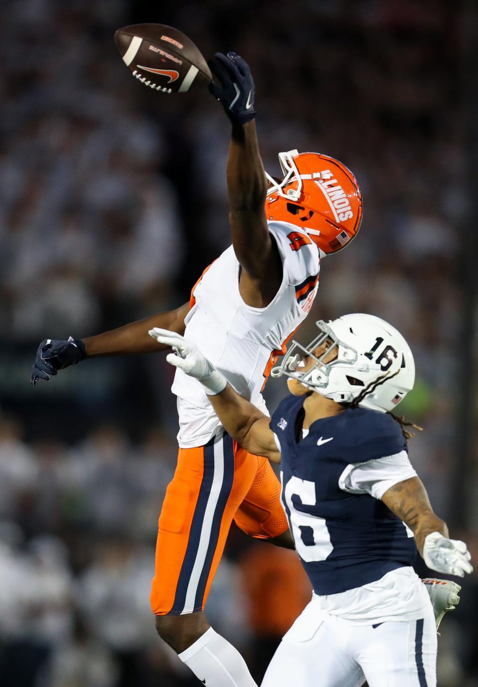 Sep 28, 2024; University Park, Pennsylvania, USA; Illinois Fighting Illini wide receiver Zakhari Franklin (4) reaches for a pass during the first quarter against the Penn State Nittany Lions at Beaver Stadium.