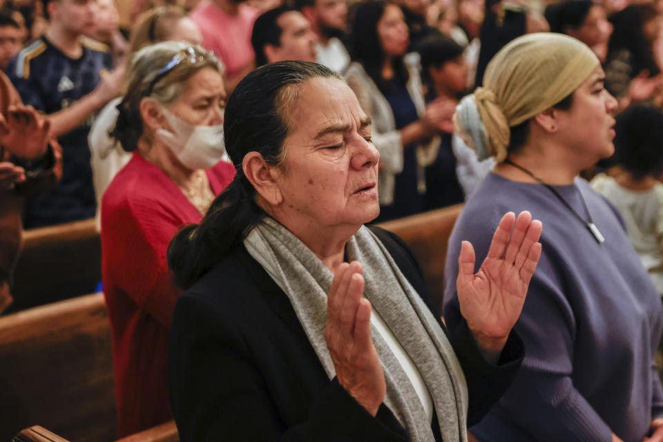 Parishioners pray during Easter Mass at Sacred Heart of Jesus and Saint Patrick, Sunday, March 31, 2024, in Baltimore, Md. (AP Photo/Julia Nikhinson)