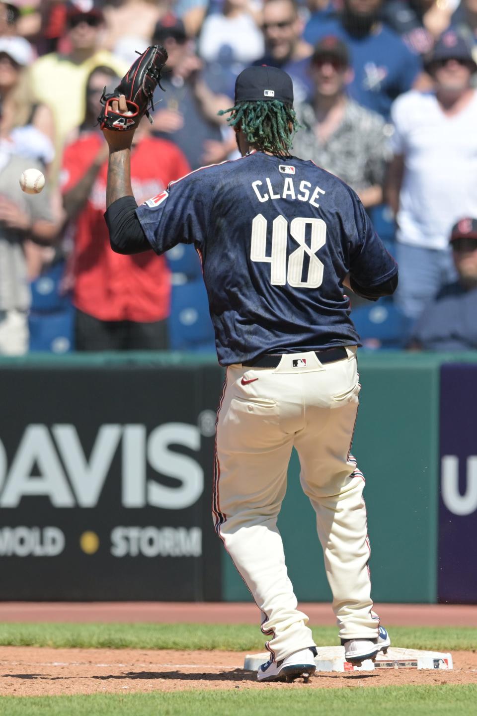 Cleveland Guardians closer Emmanuel Clase (48) drops the throw from first baseman Josh Naylor (not pictured) during the ninth inning Sunday against the Minnesota Twins in Cleveland.