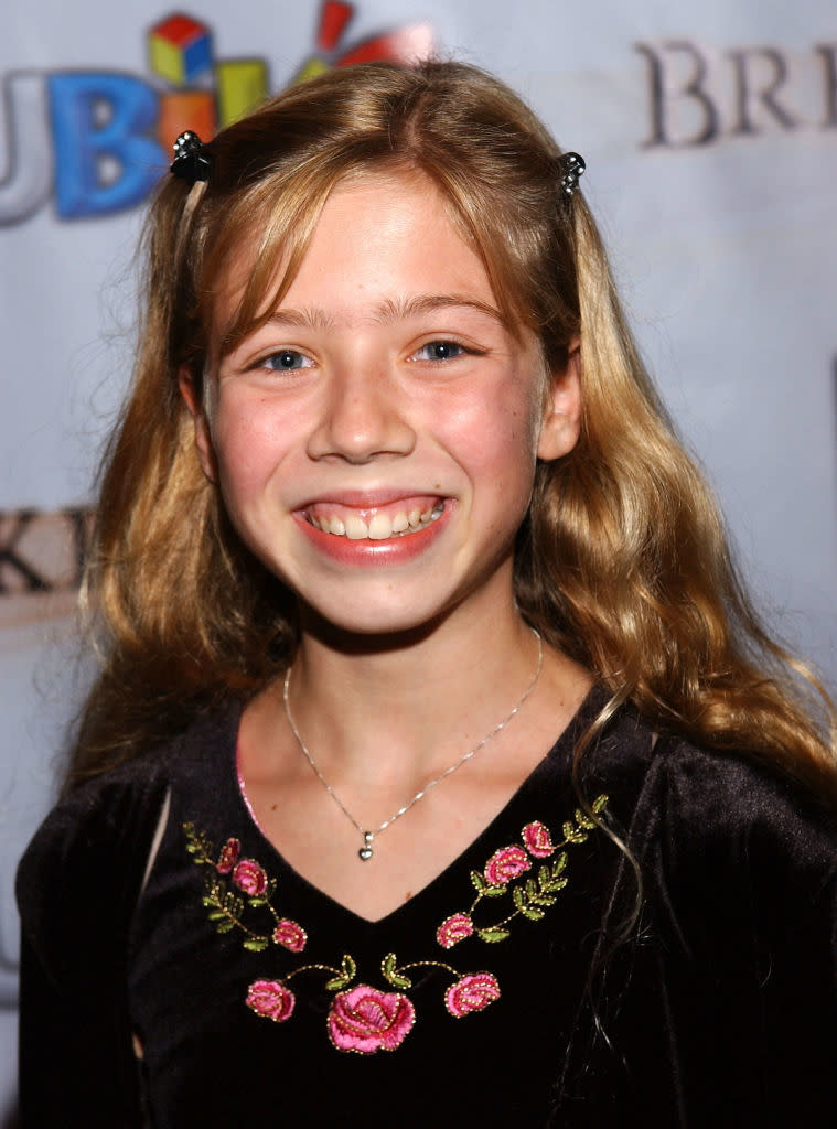 closeup of her as a kid with two butterfly clips in her hair