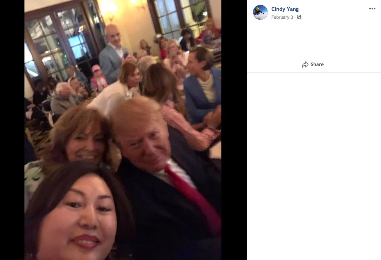 A screenshot taken from Li "Cindy" Yang's Facebook page shows her seated behind the president. (Photo: )