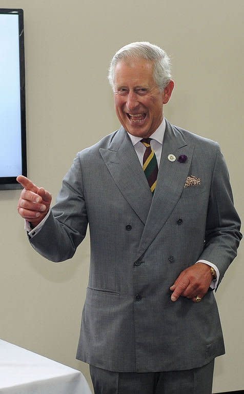 Britain's Prince Charles, Prince of Wales reacts after being given a joint of beef after his tour Dovecote Park in Pontefract, West Yorkshire on July 22, 2013