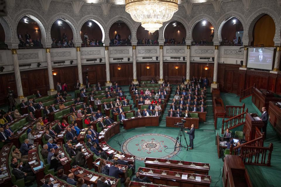 Tunisian designated Prime Minister Elyes Fakhfakh, right, delivers his speech at the parliament, Wednesday, Feb. 26, 2020. Tunisia's parliament is expected to hold a confidence vote Wednesday on designated prime minister Elyes Fakhfakh's government. (AP Photo/Hassene Dridi)