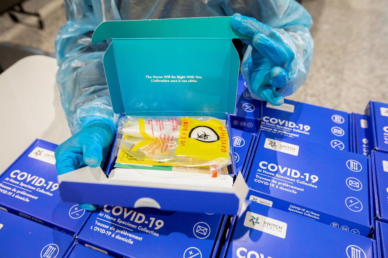 A healthcare worker shows one of the at-home COVID-19 tests given to passengers arriving in Canada, as part of the country's new measures against the coronavirus disease (COVID-19), at Toronto Pearson International Airport in Mississauga, Ontario, Canada February 24, 2021.  REUTERS/Carlos Osorio