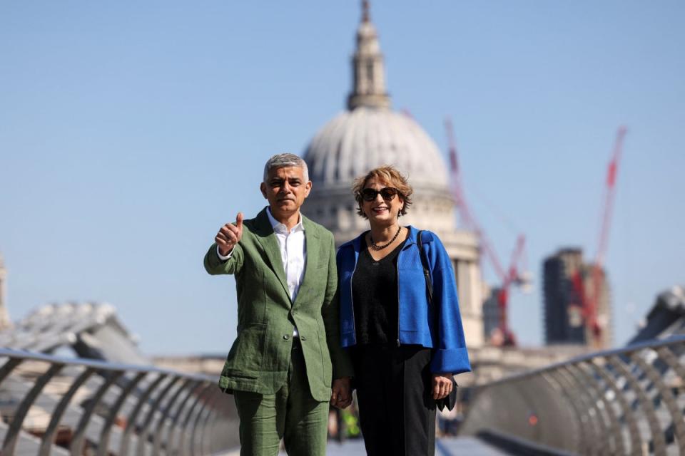 Blue sky thinking: Mr Khan with wife Saadiya on Tuesday morning (REUTERS)