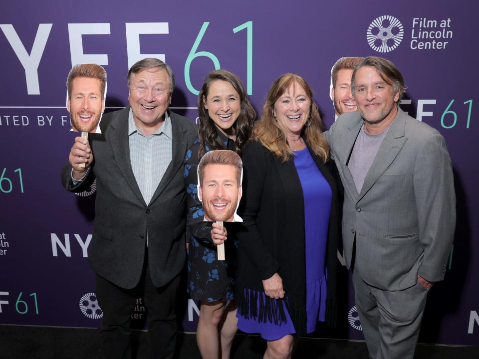 Director Richard Linklater (R) poses with Glen Powell's family as they hold photo cutout boards of him in his absence due to the SAG-AFTRA strike