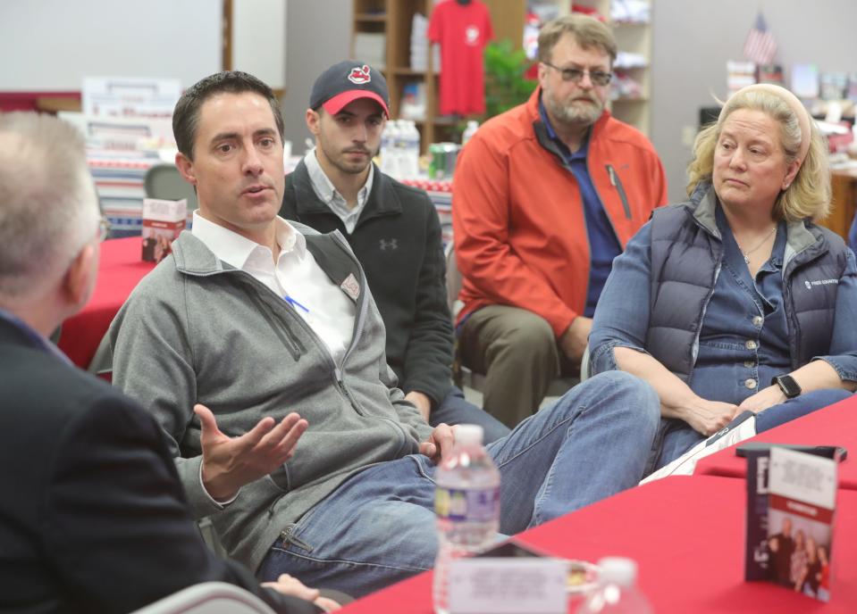 Ohio Secretary of State Frank LaRose, left, talks with supporters during a campaign stop at the Portage County Republican Headquarters in Ravenna Township on March 14.