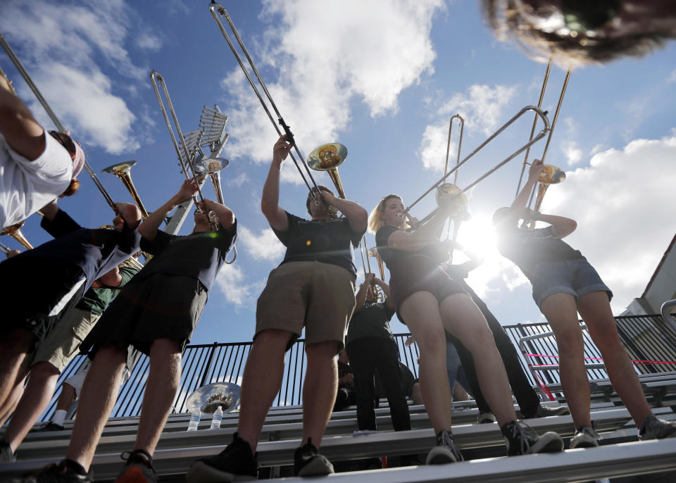 Band members from several nearby schools, who came together to play jointly at a football game between Mosley High, which suffered extensive damage from Hurricane Michael, and visiting Pensacola High, play during the game in Panama City, Fla., Saturday, Oct. 20, 2018. (AP Photo/Gerald Herbert)