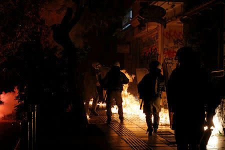 Petrol bombs explode next to riot police during clashes following an anniversary rally marking the 2008 police shooting of 15-year-old student, Alexandros Grigoropoulos, in Athens, Greece, December 6, 2017. REUTERS/Alkis Konstantinidis