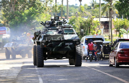 An armoured personnel carrier belonging to government troops drives along a main highway of Pantar town, Lanao Del Norte, as it travels to reinforce Marawi city, southern Philippines May 24, 2017. REUTERS/Romeo Ranoco