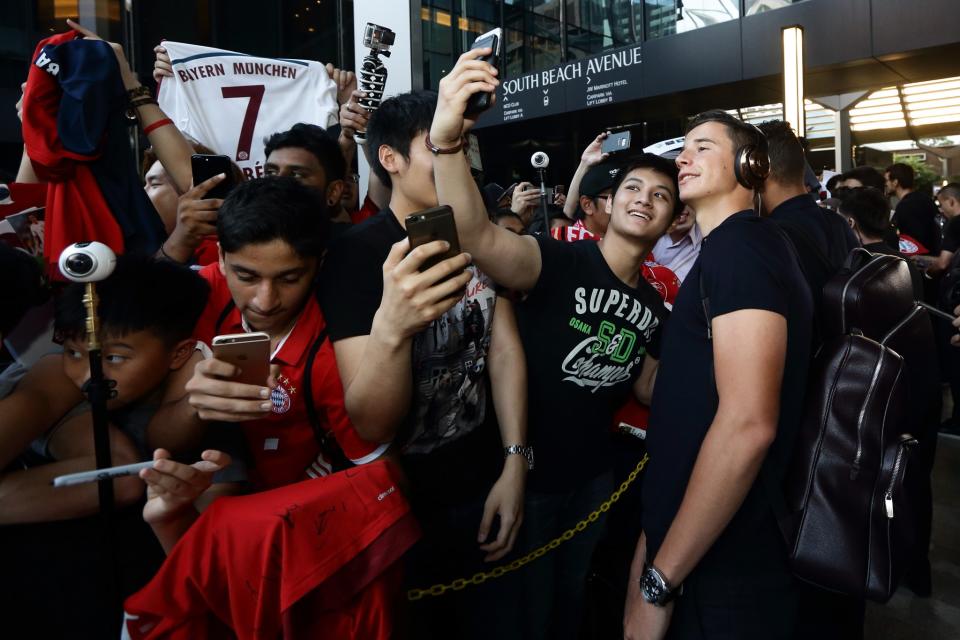 <p>Marco Friedl of Bayern Muenchen takes selfie with fans outside the team hotel </p>