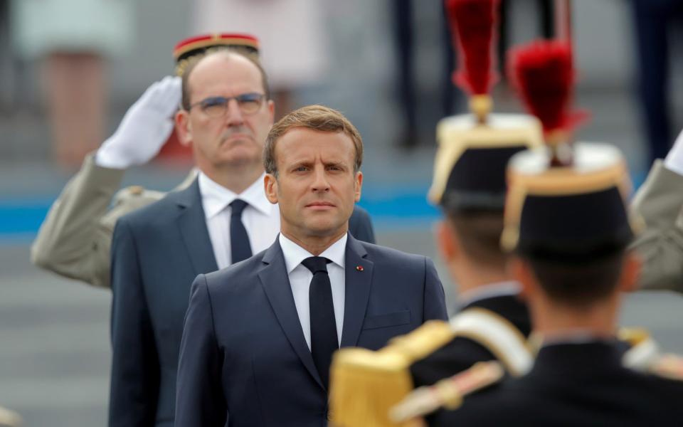 France's President Emmanuel Macron and France's Prime Minister Jean Castex review troops - REUTERS