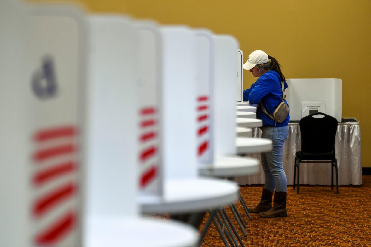 A voter fills out a ballot during early voting at the Knoxville Expo Center.