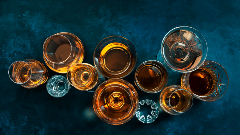 Alcohol in glasses on blue background