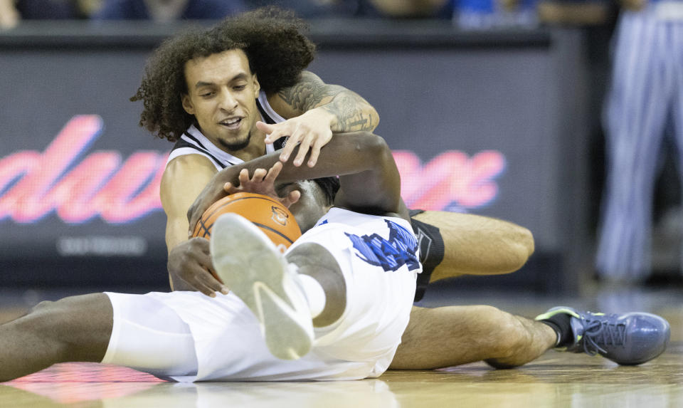 Providence's Devin Carter, top, dives for a loose ball against Creighton's Arthur Kaluma during the first half of an NCAA college basketball game on Saturday, Jan. 14, 2023, in Omaha, Neb. (AP Photo/Rebecca S. Gratz)