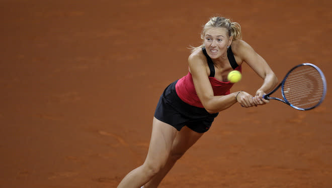 Russia's Maria Sharapova returns the ball to Belarus` Victoria Azarenka in the final match of the WTA Porsche Tennis Grand Prix in Stuttgart, southwestern Germany, on April 29, 2012. Sharapova won 6-1, 6-4. AFP PHOTO THOMAS KIENZLETHOMAS KIENZLE/AFP/GettyImages