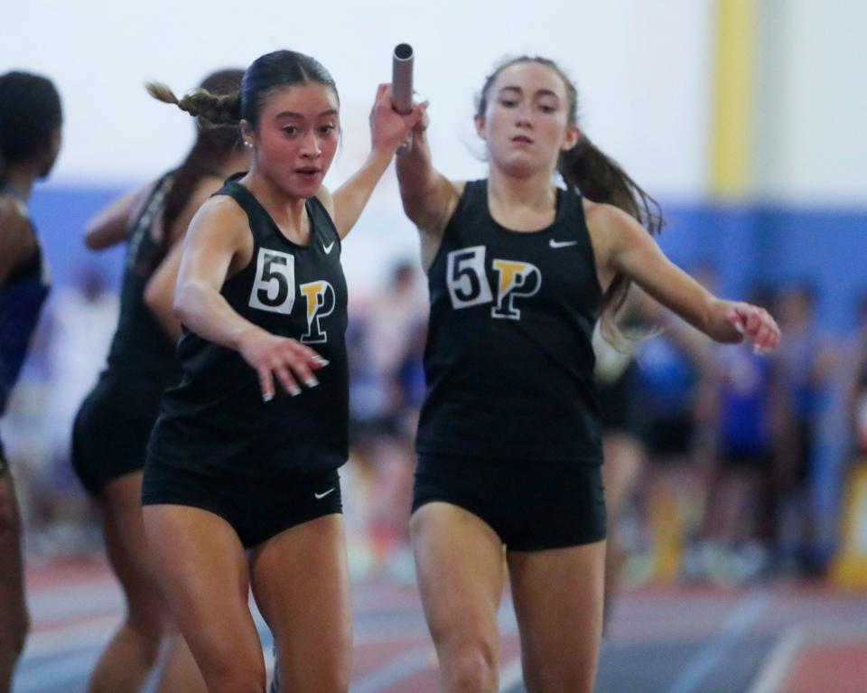 Padua's Sophia Holgado takes the baton from Molly Flanagan as their team wins the 4x400 meter relay en route to winning the event during the DIAA state high school indoor track and field championships at Prince George's Sports and Learning Complex in Landover, Md., Saturday, Feb. 4, 2023.