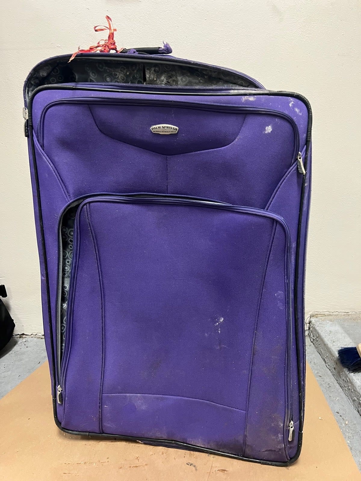 Police found the first suitcase with human remains hanging out of it when responding to a 911 call about a suspicious object in the waterway. It had been weighed down with landscaping rocks and had an airport barcode sticker for LATAM Airlines with the name 