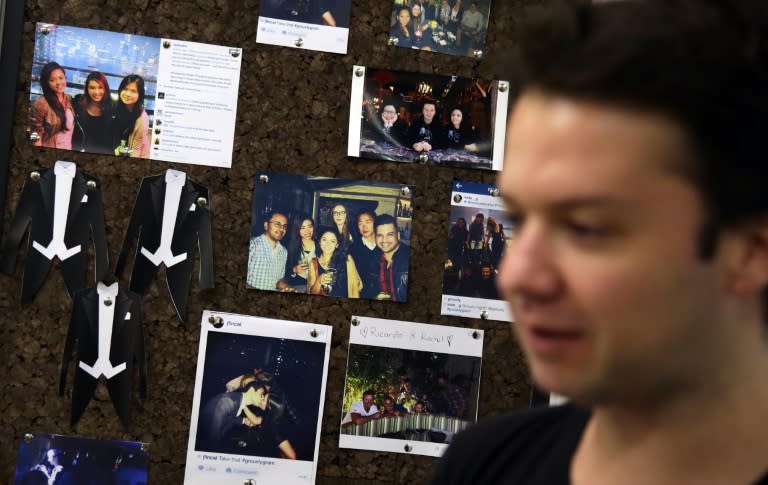 Camilo Paredes, the Colombian-born co-founder and CEO of Hong Kong-based dating app Grouvly, standing in front of a picture board of Grouvly app users at his office in Hong Kong