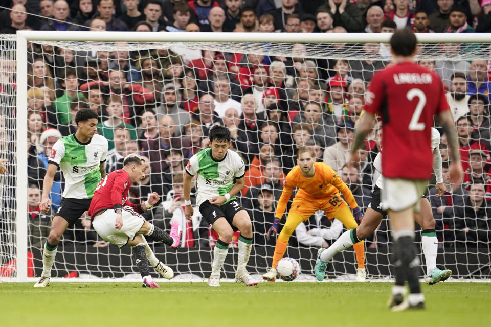 Manchester United's Antony, second left, scores his side's second goal during the FA Cup quarterfinal soccer match between Manchester United and Liverpool at the Old Trafford stadium in Manchester, England, Sunday, March 17, 2024. (AP Photo/Dave Thompson)