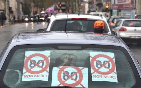 Demonstration in Agen, southern France shows a car with signs reading "80 no thank you" - Credit: MEHDI FEDOUACH/AFP