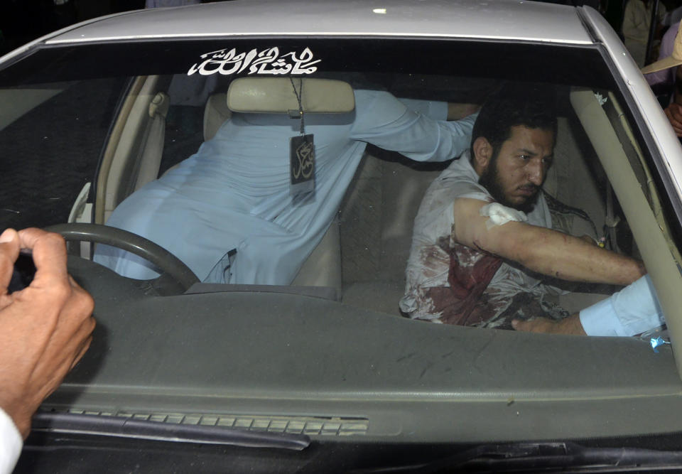 People transport an injured victim of a powerful bomb upon arrival at a hospital in Peshawar, Pakistan, Sunday, July 30, 2023. A bomb ripped through a rally by supporters of a hard-line cleric and political leader in the country's northwestern Bajur district that borders Afghanistan on Sunday, police and health officials said. (AP Photo/Muhammad Sajjad)