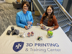 Clarkson College’s Assistant Director of Radiography/Medical Imaging and Advanced Technology Patricia (Trish) Weber (left) and 3D Printing and Training Center Administrator Blair Kauzlarich (right) showcase patient-specific boluses, surgical guides, and anatomic models 3D printed through the new partnership with 3D Systems.