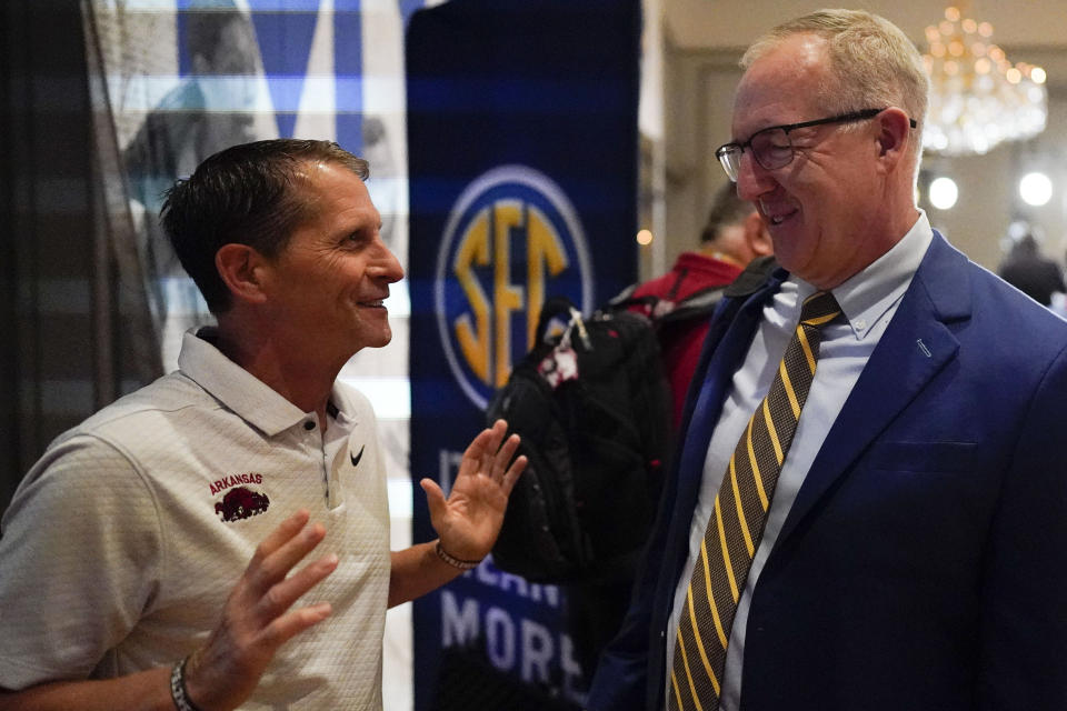 Arkansas NCAA college basketball head coach Eric Musselman, left, speaks with Commissioner of the SEC Greg Sankey during Southeastern Conference Media Days, Wednesday, Oct. 18, 2023, in Birmingham, Ala. (AP Photo/Mike Stewart)