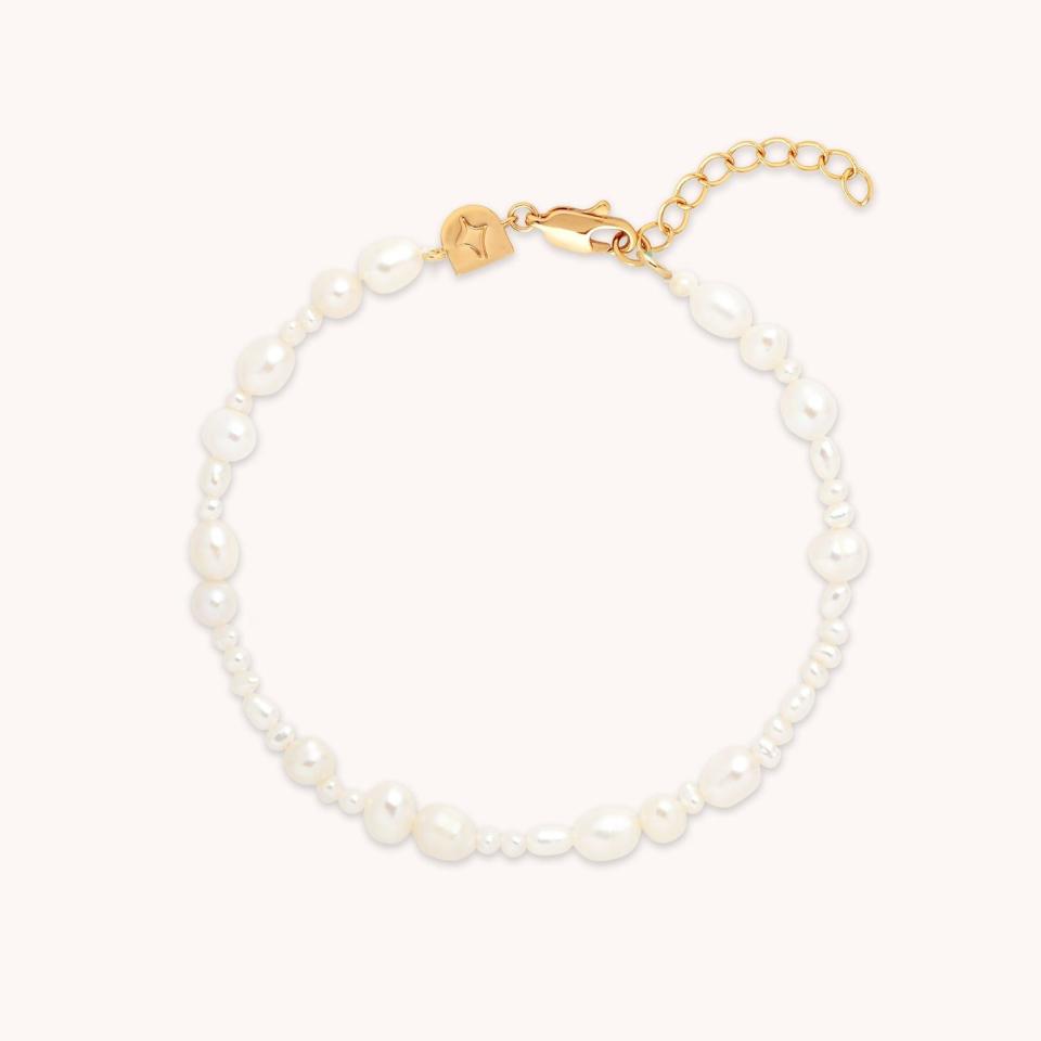 <p><a href="https://go.redirectingat.com?id=74968X1596630&url=https%3A%2F%2Fus.astridandmiyu.com%2Fproducts%2Fserenity-pearl-bracelet-in-gold&sref=https%3A%2F%2F" rel="nofollow noopener" target="_blank" data-ylk="slk:Shop Now;elm:context_link;itc:0;sec:content-canvas" class="link ">Shop Now</a></p><p>18K Gold Plated Serenity Pearl Bracelet</p><p>astridandmiyu.com</p><p>$95.00</p>