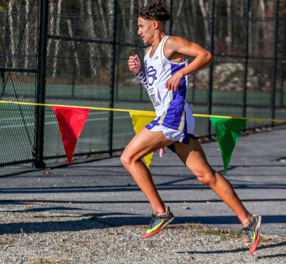 Devan Kipyego, St Raphael  comes out of the trees all alone as he hits the final stretch of Boy's Cross Country State Championship.