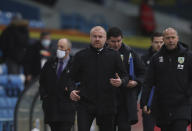 Burnley's manager Sean Dyche, centre, leaves after the first half time during the English Premier League soccer match between Leeds United and Burnley at Elland Road Stadium in Leeds, England, Sunday, Dec. 27, 2020. (Molly Darlington/Pool via AP)