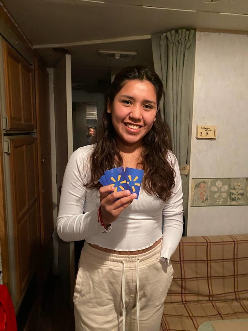 Brigite Valverde was 23 when she lost part of her left arm in a meat grinder accident in Bolivia in 2022. She holds some Walmart gift cards she received in the Miami Herald and el Nuevo Herald’s Wish Book 2023 season. She’s awaiting word on whether she may receive a functioning prosthetic arm as donors assess estimated cost quotes.