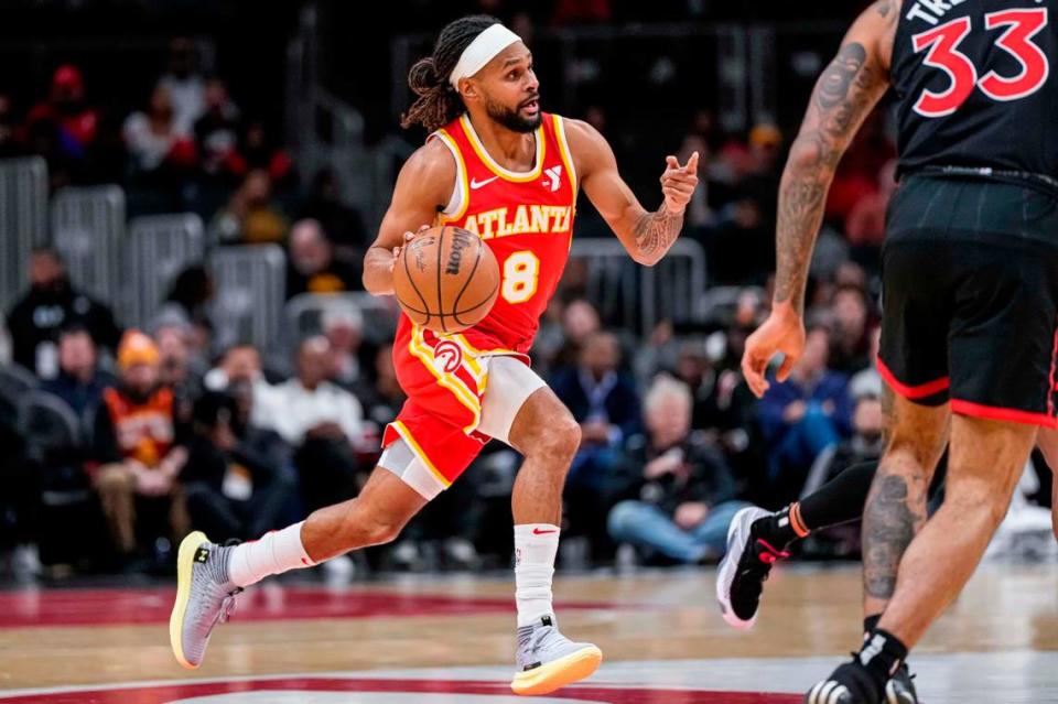 Then-Atlanta Hawks guard Patty Mills (8) brings the ball up the court against the Toronto Raptors during the first half at State Farm Arena.